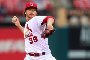 身穿 Cardinals 球衣的棒球投手在比賽中投球。 — 棒球 壁紙