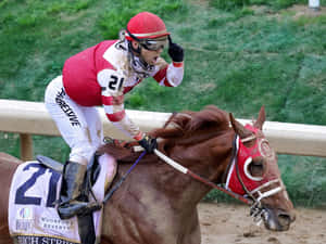 騎師在肯塔基德比賽馬中騎著獲勝賽馬慶祝勝利 — 高解析度馬匹 壁紙