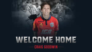 足球員 Craig Goodwin 身穿紅色球衣，背後有「Welcome Home」文字。 — 足球員 壁紙