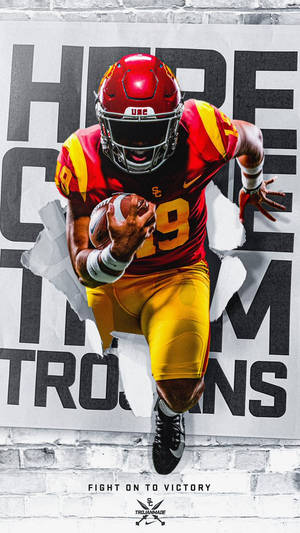 USC Trojans美式足球員衝破磚牆上的海報。 — 運動 壁紙