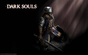 一名身穿暗色盔甲的騎士在 Dark Souls 的昏暗場景中持劍跪地。 — 黑暗靈魂 GIF 壁紙