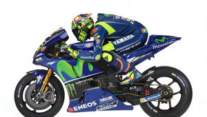 身穿藍綠色裝備的摩托車賽車手駕駛Yamaha MotoGP摩托車。 — 機車 壁紙