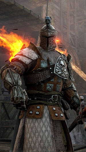 一名中世紀騎士身穿飾有骷髏設計的華麗盔甲，站在廢墟石環境中的火焰前。 — 榮耀戰魂 壁紙