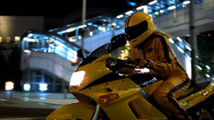 全副裝備的黃色機車騎士，夜晚在城市街道上。 — 追殺比爾 壁紙