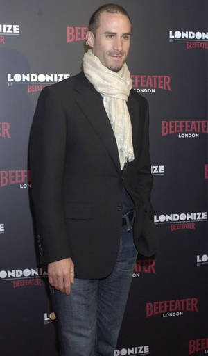男子在Beefeater London活動中穿著黑色西裝外套和奶油色圍巾。 — 好萊塢 壁紙