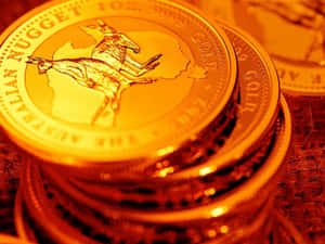 一堆澳洲金幣，袋鼠圖案溫暖發光。 — 金色動態 壁紙