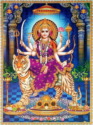印度教女神杜爾迦（Durga）有十臂騎著老虎，手持武器和蓮花。 — 金廟 壁紙