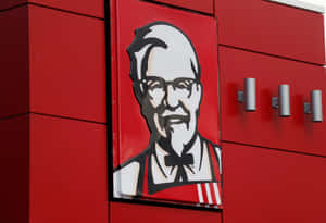 KFC餐廳外觀，紅色牆上有桑德斯上校標誌。 — 肯德基 壁紙