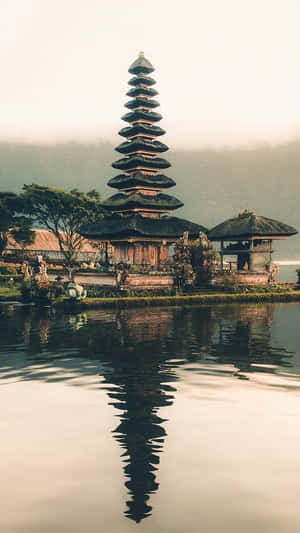 峇里島寺廟倒映在靜止的水面上，背景迷濛 — 唐人街 壁紙