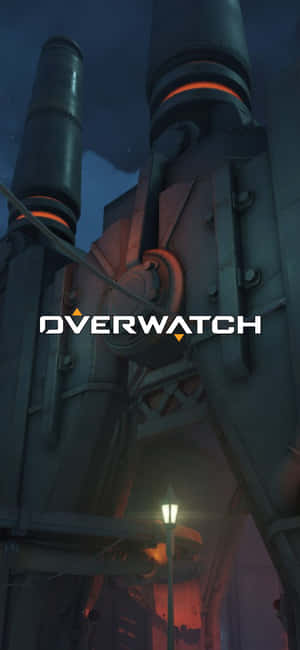 夜間未來工業建築上的遊戲標誌Overwatch。 — iPhone 16 Plus 壁紙