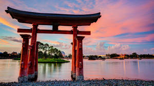 日落時分的紅色鳥居倒映在平靜的水面上，天空色彩繽紛 — 日式 壁紙