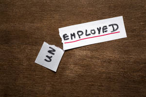 撕破的紙張上 'EMPLOYED' 被劃掉，撕口處露出 'UN'。 — 插畫 壁紙