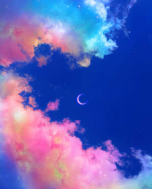 一彎新月在繁星點點的夜空中穿過色彩繽紛的雲層閃耀。 — 月光 壁紙
