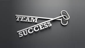 一把金屬鑰匙，形狀為 'TEAM SUCCESS' 字樣，位於灰色表面上。