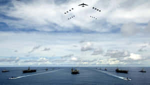 軍用航空母艦和軍艦在公海上編隊航行。
