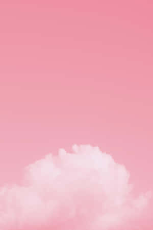 一朵蓬鬆的雲朵在柔和的粉紅色天空中。 — 粉紅色 壁紙
