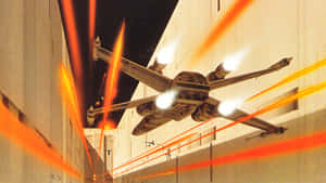 星際戰機在夜間建築物之間的峽谷中躲避雷射攻擊。 — 星際大戰 壁紙