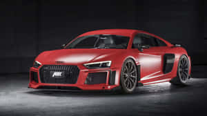 啞光紅色ABT Audi R8跑車在黑暗車庫中，聚光燈照射。 — 奧迪 GIF 壁紙