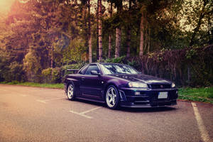 深紫色跑車停在森林道路上的日落時分。 — 日產Skyline GTR R33壁紙