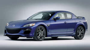 藍色Mazda RX-8跑車配黑色輪圈，在攝影棚燈光下。 — 馬自達 壁紙