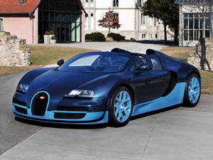 日落時分，一輛藍色Bugatti Veyron停在豪宅前。 — Bugatti iPhone 壁紙