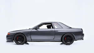深灰色日產Skyline GT-R，配備黑色輪圈和紅色制動卡鉗，在白色工作室中。 — 日產 Skyline GTR R34 壁紙