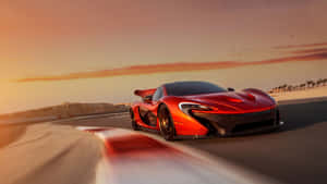 紅色McLaren P1在日落時分於海岸公路上疾馳，帶有動態模糊效果。 — 超跑 壁紙