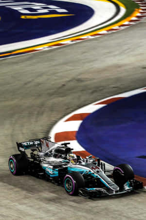 F1賽車在明亮的燈光下於夜間賽道彎道疾馳。 — 小米平板 7 Ultra 壁紙