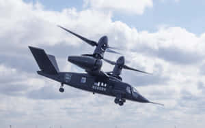 黑色Bell V-280 Valor傾轉旋翼機飛行中，起落架已放下。 — 直升機 壁紙