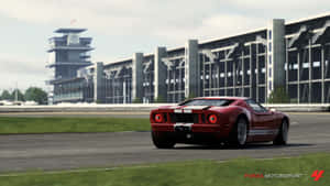 紅色福特GT40賽車在賽道上，有看台和控制塔。 — 汽車 壁紙