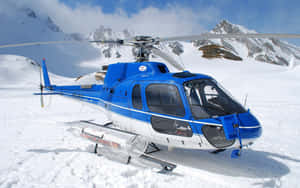 藍白直升機停泊在積雪的山地地形上。 — 直升機 壁紙