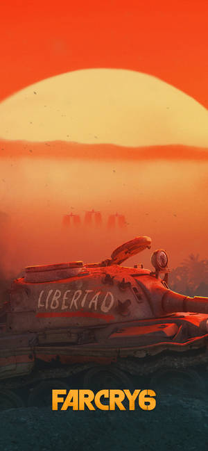一架鏽跡斑斑的坦克，標有「LIBERTAD」，在日落時的沙漠中，遠處可見船隻。 — Galaxy S26 壁紙
