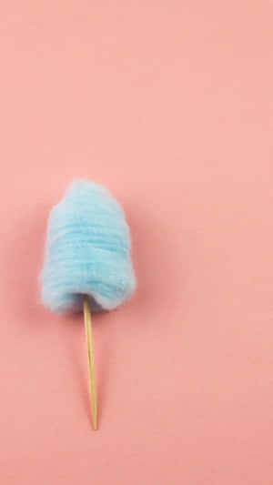 藍色棉花糖在棍子上，粉紅背景 — 低對比 壁紙