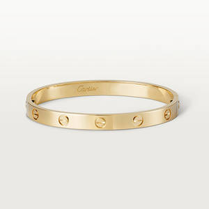 黃金Cartier love手鐲，帶螺絲細節，白色背景 — 金色動態 壁紙