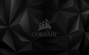 黑色幾何壁紙，Corsair 標誌居中。