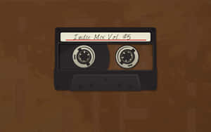 在棕色紋理背景上，一盒標有 Indie Mix Vol 5 的黑色卡式錄音帶 — 美學音樂 壁紙
