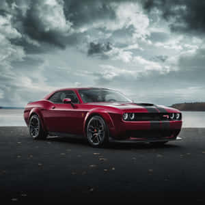 紅色Dodge Challenger SRT在暴風天空下停泊在近水處。 — 道奇挑戰者 壁紙