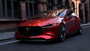 一輛紅色Mazda跑車在黃昏時分行駛在城市街道上。 — 馬自達 壁紙