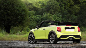 青檸綠色MINI Cooper敞篷車停泊在森林中的碎石上。 — 螢光綠 壁紙