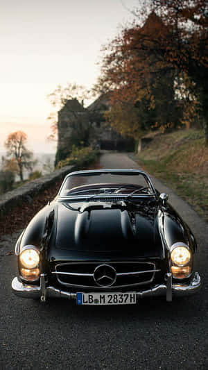 黑色 vintage Mercedes-Benz 敞篷車在秋季道路上，夕陽下。 — Mercedes Benz C300 壁紙