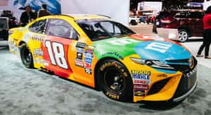 色彩繽紛的M&M's NASCAR賽車18號在汽車展上展示 — 賽車 壁紙
