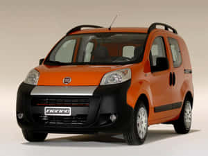 橙色和黑色的 Fiat Fiorino 貨車在攝影棚燈光下。 — 飛雅特 壁紙