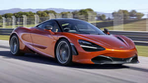 橙色McLaren 720S在賽道上疾馳，背景模糊。 — 4K 法拉利 壁紙