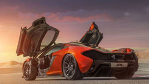 橙色McLaren P1超級跑車在日落時分的賽道上打開車門。 — 好看汽車 壁紙