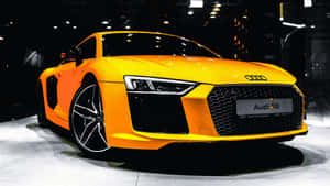 亮橙色奧迪R8跑車在車展上展出。 — 奧迪 GIF 壁紙