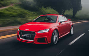 紅色奧迪 TT RS Sport Coupe 在森林道路上飛馳，帶有動態模糊效果。 — Steam Deck 壁紙
