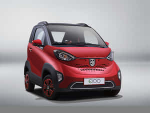紅色緊湊型電動車，帶有黑色飾邊和合金輪轂，在工作室環境中。 — 動漫汽車 壁紙