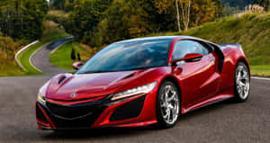 白天在蜿蜒的森林道路上的紅色跑車 — Acura 壁紙