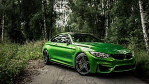 綠色BMW M4停放在被樹木環繞的林間道路上