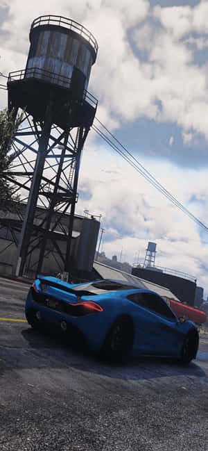 藍色跑車停在工業區的舊水塔附近。 — 電玩遊戲 GIF 壁紙